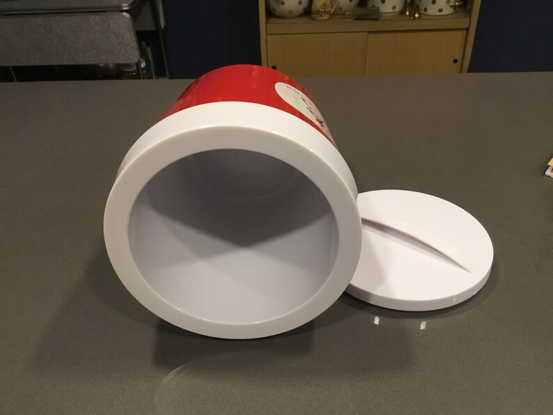 May include: A red and white insulated cooler with a white lid. The cooler is open and the inside is white.