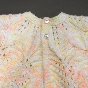 Babys sweater, hand knit in a slightly sparkly white melon yellow pink variegated pattern w 2 pearlized buttons, scalloped bottom -Beautiful