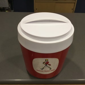 May include: Red and white cooler with a white lid and a Johnnie Walker Red label featuring a man in a walking pose.