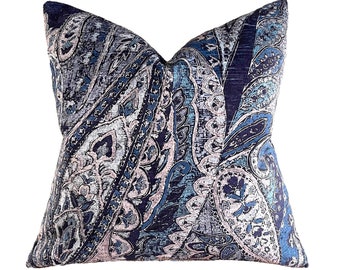 May include: A blue and pink paisley patterned throw pillow with a textured fabric.