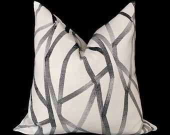 May include: A white pillow with a black and gray abstract pattern of lines and curves.