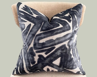 May include: A black and white patterned throw pillow with an abstract design. The pillow is made of a soft, plush fabric.