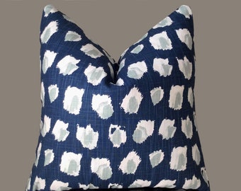 May include: A blue and white patterned throw pillow with a geometric design. The pillow is made of a soft, textured fabric.