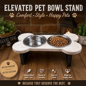 May include: An elevated pet bowl stand shaped like a bone with a distressed white finish and black legs. It features two circular stainless steel bowls, one containing water and the other filled with dry pet food. Text includes ELEVATED PET BOWL STAND.