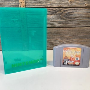 Op de afbeelding: Een grijze Nintendo 64-gamecartridge voor het spel "T-Squad: Hyper Bike" met een gele, oranje en rode achtergrond. De gamecartridge staat naast een doorzichtige groene plastic behuizing met het Nintendo 64-logo.