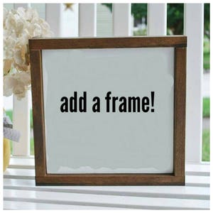 May include: A brown wooden frame with a white background and the text "add a frame!" in black lettering.