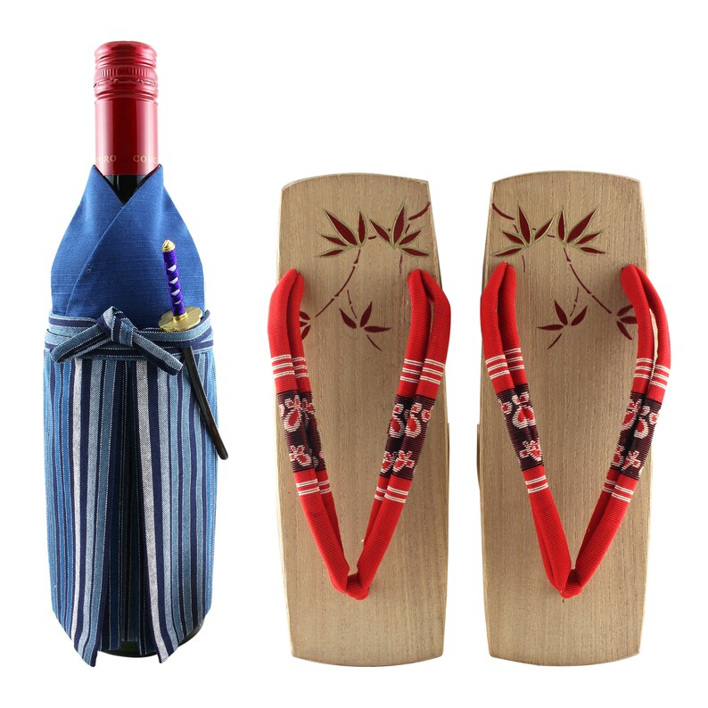 May include: A wine bottle wrapped in a blue and white striped fabric with a red and gold design. The bottle is next to two wooden geta sandals with red and white straps.