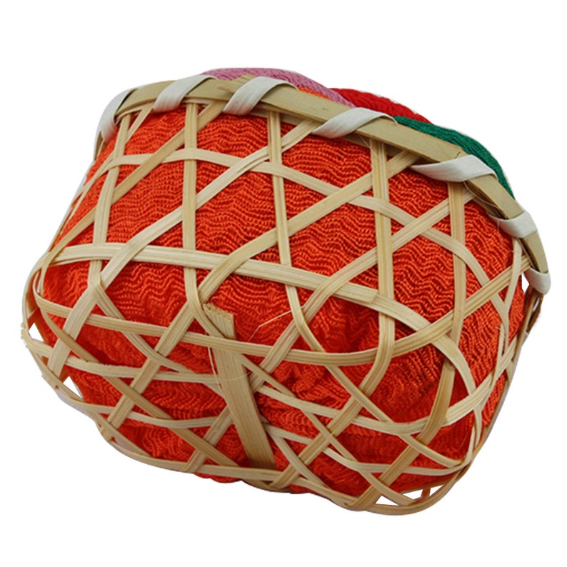 May include: A small, orange, woven basket with a bamboo frame. The basket is lined with a red, green, and pink fabric.