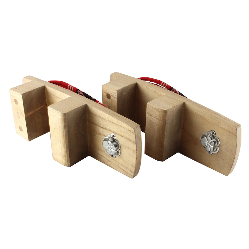 May include: A pair of wooden Japanese sandals, known as geta, with red and white fabric straps. The sandals have a raised wooden base and a decorative metal flower design on the sole.
