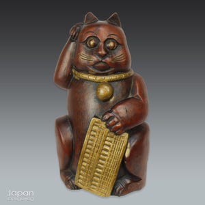 vintage japanese bamboo maneki neko - traditional japanese lucky charm
