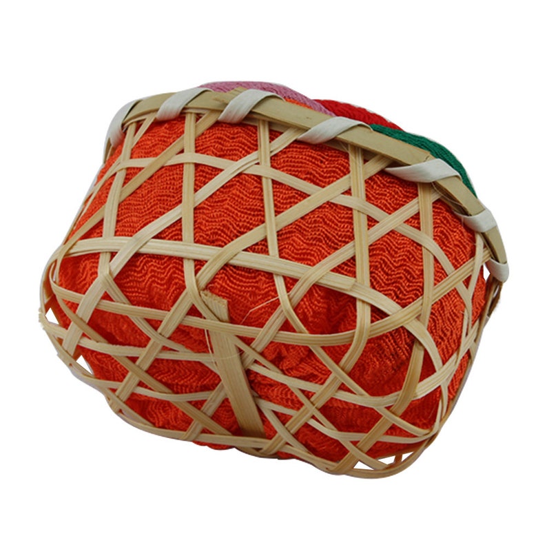 May include: A small, round, orange woven basket with a bamboo frame. The basket is lined with a red fabric and has a colorful woven trim around the top.