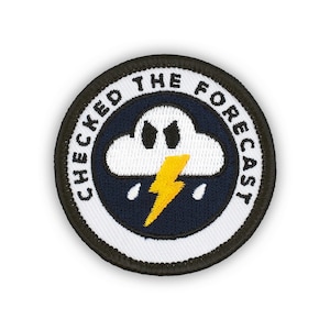 May include: White embroidered patch with black stitching. The patch features a white cloud with black eyes and a yellow lightning bolt inside. The text "CHECKED THE FORECAST" is written in black around the cloud.