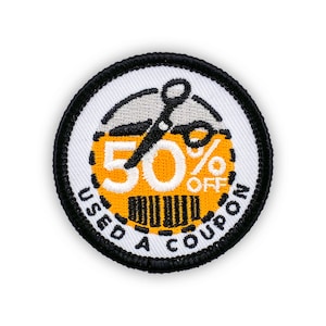 May include: Circular embroidered patch with a white background and a black border. The patch features a yellow and black design with the text "50% OFF" and "USED A COUPON". A pair of scissors is also included in the design.