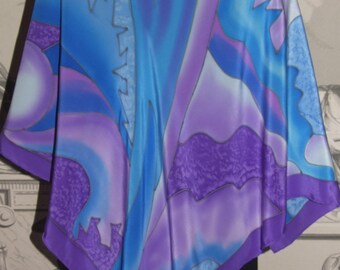 May include: A silk scarf with a blue and purple abstract design. The scarf is hand-painted with a flowing, organic pattern.