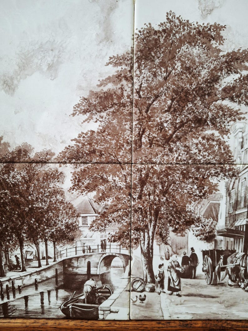 May include: A sepia-toned tile mural depicting a European canal scene. The artwork shows a bridge, trees, buildings, and figures in period clothing. A horse-drawn carriage is visible on the right side. The mural is composed of four tiles.