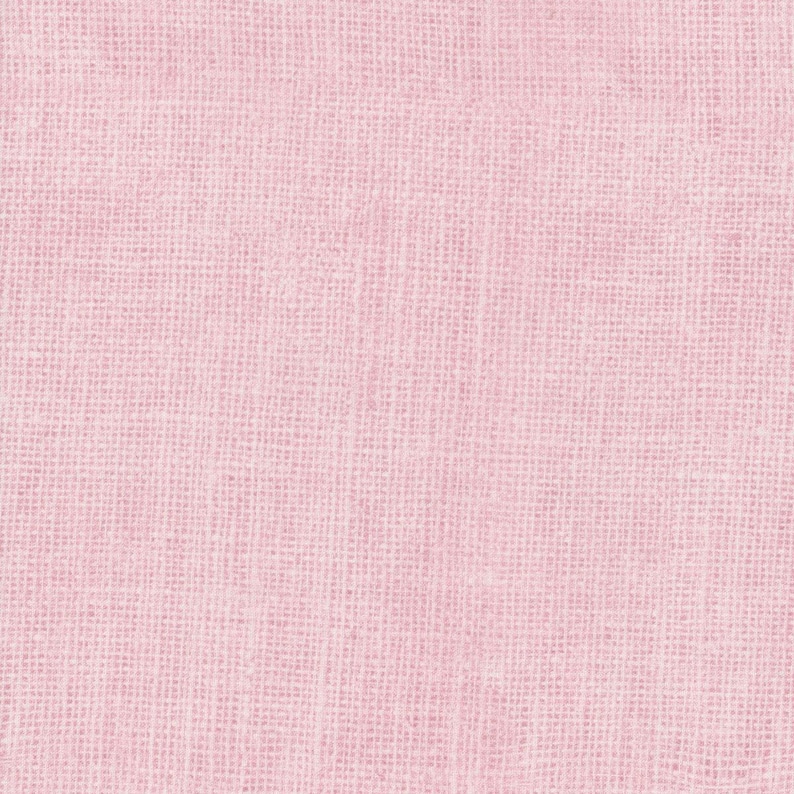 May include: Close-up of a light pink woven fabric. The texture of the material is visible, with a slightly irregular pattern. The color is a soft, muted pink, and the fabric appears to be lightweight.