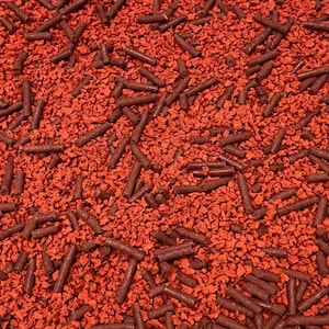 May include: Red and brown sprinkles for baking and decorating. The sprinkles are in a variety of shapes and sizes.