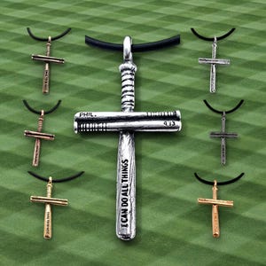May include: Seven silver baseball bat cross pendants on black cords. The center pendant has the words "I can do all things" inscribed on the bat. The other pendants have the words "Phil. 4:13" inscribed on the bat.