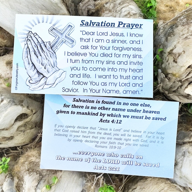 May include: Two blue and white cards with a Christian prayer for salvation. The first card features a drawing of hands in prayer with a cross. The text on the card reads "Salvation Prayer" and includes a prayer to Jesus. The second card features the text "Salvation is found in no one else, for there is no other name under heaven given to mankind by which we must be saved Acts 4:12". The card also includes a quote from Romans 10:9-10 and Acts 2:21.