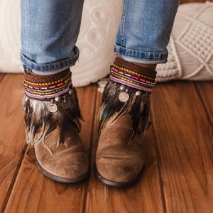 Unique boot covers with brown feather fringe, multicolored beaded trim, and ancient Indian coin accents