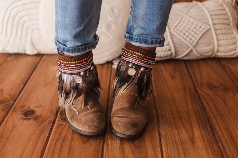 Unique boot covers with brown feather fringe, multicolored beaded trim, and ancient Indian coin accents