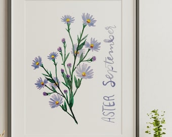 May include: A framed print with a watercolor illustration of purple aster flowers. The text "ASTER September" is written vertically on the right side of the print.