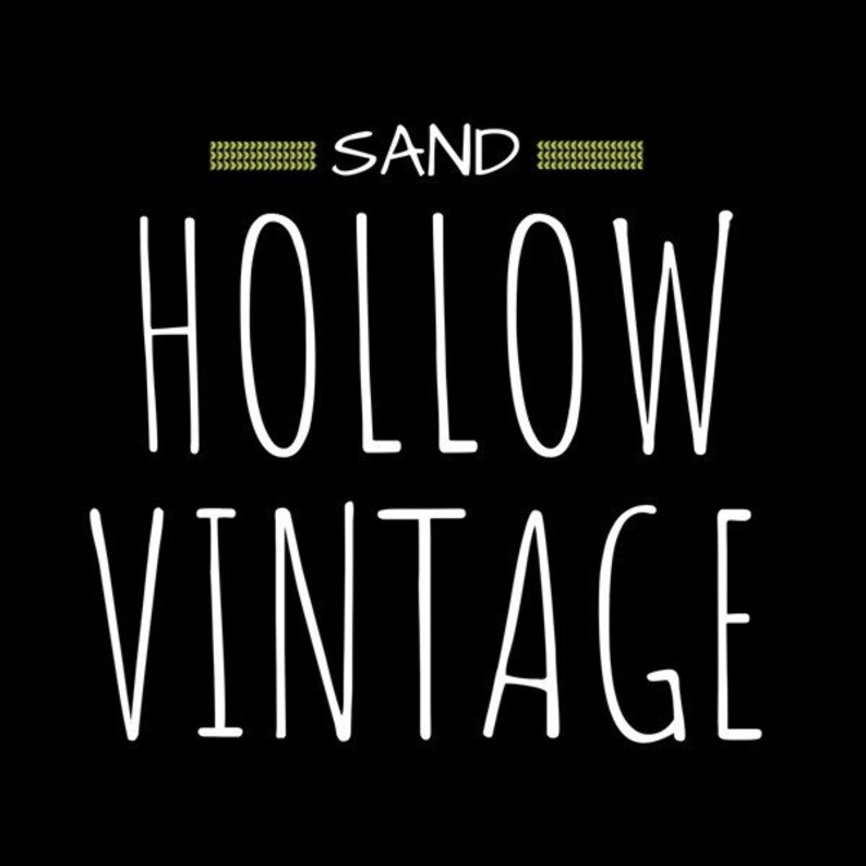 May include: Black and white graphic text design with the words "SAND HOLLOW VINTAGE" on a black background.