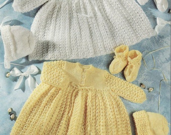 May include: Two sets of knitted baby clothing, each including a long-sleeved dress with a buttoned bodice, a matching bonnet, and a pair of booties. One set is white and the other is pale yellow, both featuring a textured, openwork knit pattern.