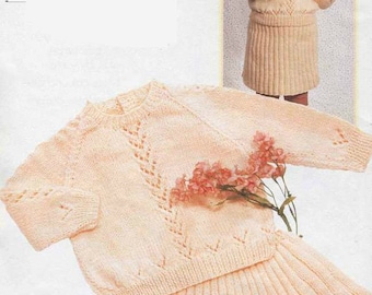 May include: A pale peach knitted two-piece set consisting of a long-sleeved sweater with a delicate openwork pattern and a matching pleated skirt. The text 18 to 22 inches and 3 to 7 balls is printed on the page, accompanied by a small photo.