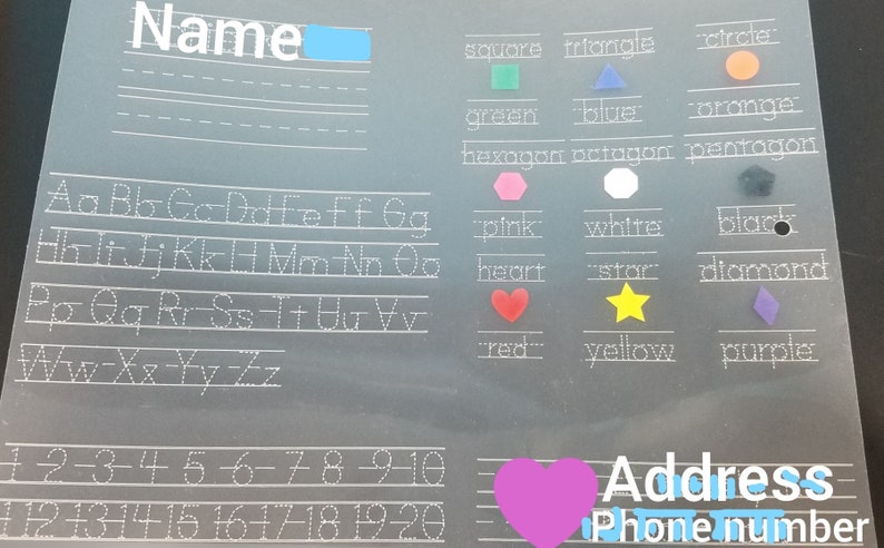 May include: A clear plastic sheet with dotted lines for tracing letters, numbers, and shapes. The sheet includes a section for writing a name, address, and phone number. The sheet also includes a color chart with shapes and colors, including red, yellow, blue, green, orange, pink, white, black, and purple.