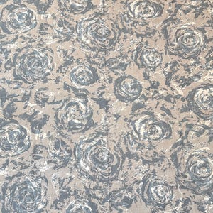 May include: A fabric with a repeating pattern of stylized roses in shades of gray, white, and beige. The roses are painted with a brushstroke effect, creating a textured appearance. The fabric has a neutral color palette, suitable for various home decor projects.