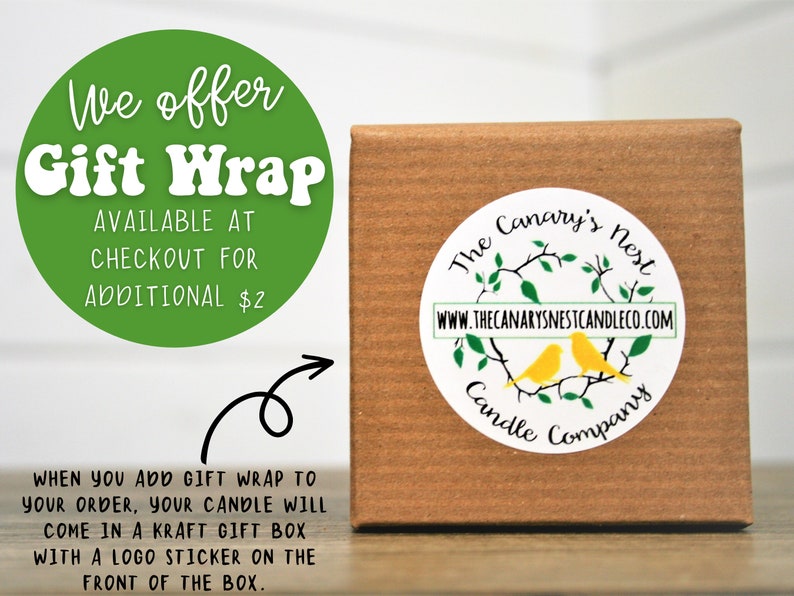 May include: A brown kraft gift box with a white sticker featuring a logo of two yellow birds on a branch with green leaves. The text on the sticker reads "The Canary's Nest Candle Company" and "www.thecanarysnestcandleco.com". A green circle with white text reads "We offer Gift Wrap Available at Checkout for Additional $2".