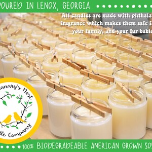 May include: A close-up of a row of candles in glass jars, with wooden clothespins holding wicks in place. The candles are a pale yellow color and are arranged on a wooden surface. The text "The Canary's Nest Candle Company" is visible in a yellow circle with a green leafy design. The text "100% BIODEGRADEABLE AMERICAN GROWN SOY WAX" is visible at the bottom of the image.