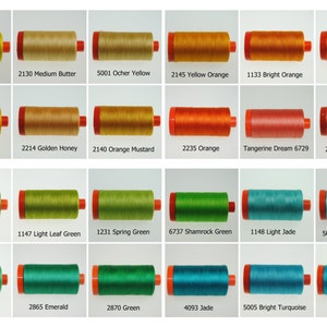 May include: A collection of 24 spools of thread in various shades of yellow, orange, green, and blue. Each spool is labeled with a color name and a number.