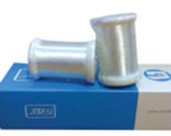 May include: Two spools of clear white thread on a blue and white box. The box has the text "Lucky Fit" printed on it.