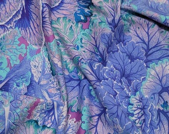May include: A fabric with a floral pattern of blue and green leaves on a light purple background.
