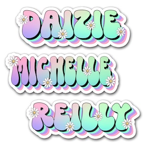 May include: Three stickers with names: "DAIZIE", "MICHELLE", and "REILLY". Each name is in a bubble letter style with a pastel rainbow gradient and white daisy accents. The stickers have a white border and a shadow effect.