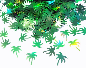 May include: Green iridescent palm tree confetti. The confetti is scattered on a white background.