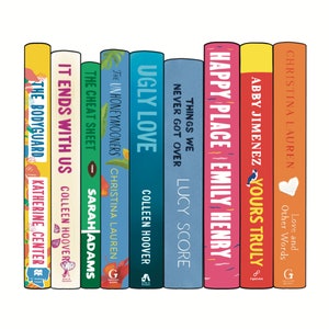 May include: A collection of colorful book spines, each with unique titles and author names. Titles include "The Bodyguard," "It Ends With Us," "Ugly Love," and "Happy Place." The books are arranged vertically, showcasing a variety of cover designs and fonts.