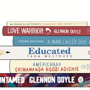 May include: A stack of seven books with various titles and authors. The titles include "We Should All Be Feminists," "Love Warrior," "A Man Called Ove," "Educated," "Americanah," and "Untamed." The books are in different colors, with text visible.