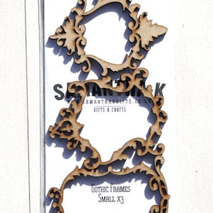 May include: Three small, intricately designed, wooden frames in a clear plastic bag. The frames are in a gothic style with a decorative, ornate design. The text "Gothic Frames Small X3" is printed on the white card inside the bag.