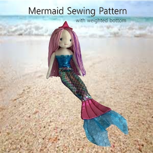 May include: A mermaid sewing pattern with a weighted bottom. The pattern includes a pink and blue mermaid tail with a sparkly iridescent finish.