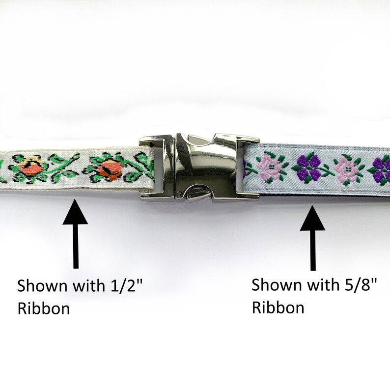 May include: A silver metal buckle with two different floral patterned ribbons. The ribbon on the left is white with green and orange flowers and is shown with 1/2" ribbon. The ribbon on the right is light blue with pink and purple flowers and is shown with 5/8" ribbon.