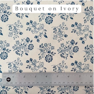May include: Ivory fabric with a repeating pattern of navy blue floral bouquets and foliage. The text "Bouquet on Ivory" is at the top. A ruler shows measurements up to 8 inches.