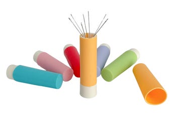 May include: A set of six colorful needle holders with a central holder containing multiple needles. The holders are in shades of pink, red, blue, green, and orange.