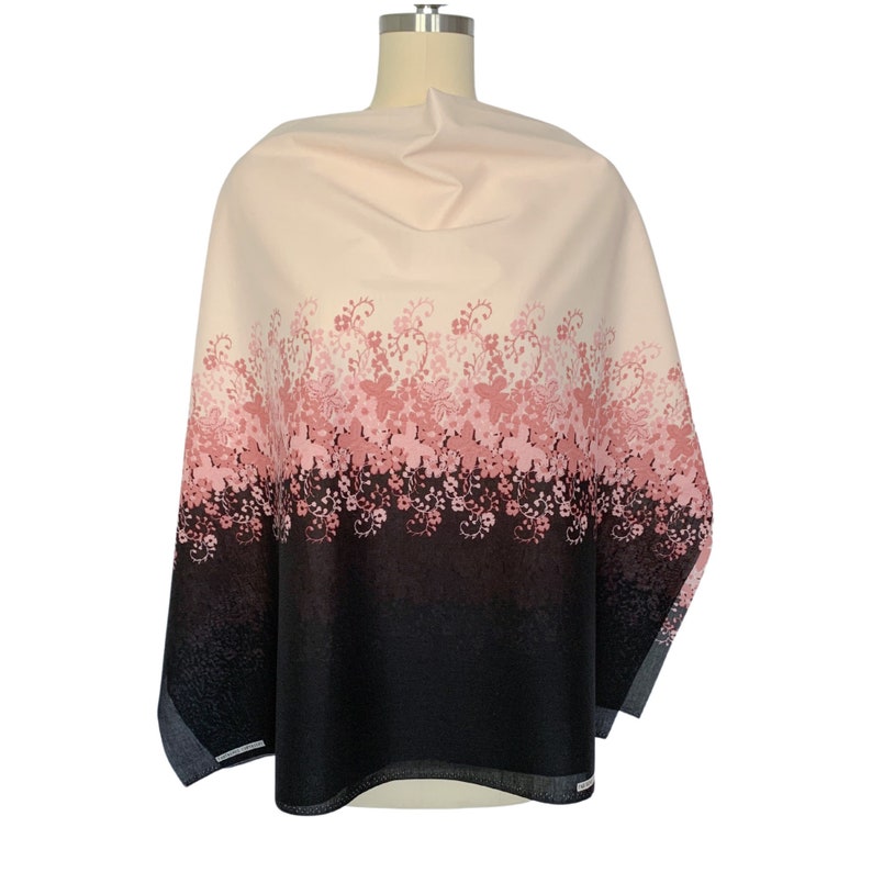 May include: A cream-colored fabric with a pink and black floral print. The print features a gradient of pink flowers fading into black.