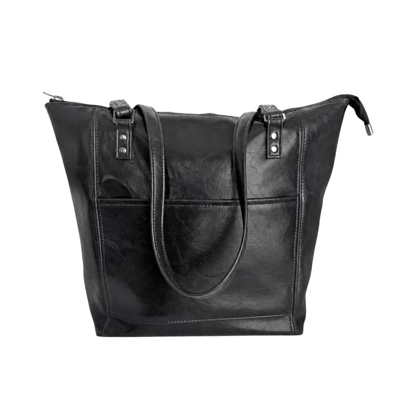 May include: A black tote bag with a smooth, slightly glossy finish, featuring two shoulder straps attached with silver-toned metal rivets, a horizontal front pocket, and a top zipper closure that extends slightly beyond the bag's main body.