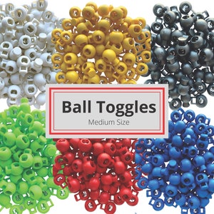 May include: Assortment of colorful plastic ball toggles in white, yellow, green, red, blue, and black. The toggles are medium size and are arranged in a circle with the text "Ball Toggles Medium Size" in the center.