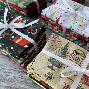 May include: A stack of Christmas fabric squares with various holiday patterns, including candy canes, snowflakes, and Christmas trees. The fabric is tied with white ribbon.