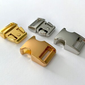 May include: Three metal clasps in gold, silver, and rose gold. The clasps are side release buckles, commonly used for dog collars, leashes, and other straps.